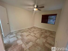 Miami apartment for rent - A room with a ceiling fan and tiled floor.
