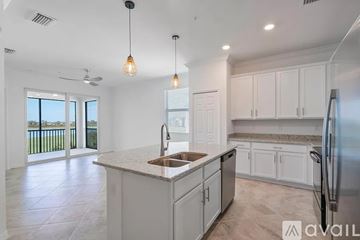 Punta Gorda apartment for rent - A kitchen with white cabinets and a marble countertop.