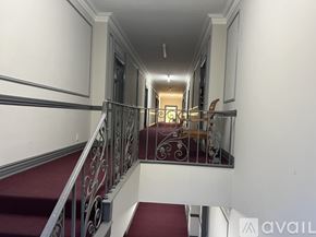 Los Angeles apartment for rent - A staircase with a red carpet and metal railing.
