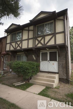Colorado Springs townhouse for rent - A bedroom with a bed, chair, and painting on the wall.