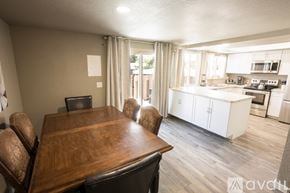 Colorado Springs townhouse for rent - A dining room with a wooden table and chairs is shown.