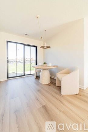 Columbiana townhouse for rent - A modern dining room with a table and chairs.