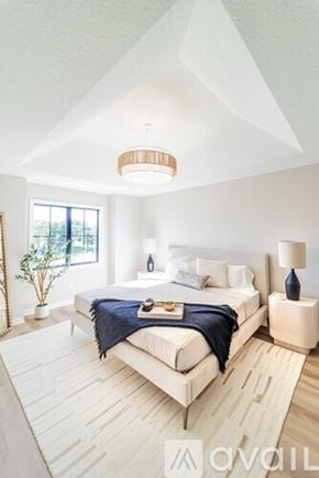 Columbiana townhouse for rent - A bedroom with a large bed and a lamp on the side table.