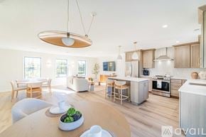 Columbiana townhouse for rent - A modern kitchen with wooden chairs and cabinets.