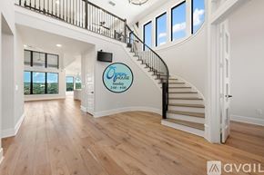 Austin house for rent - A spacious room with a staircase and a flat screen TV mounted on the wall.