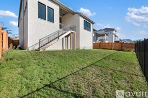 Austin house for rent - A house with a white exterior and a black fence is for sale.