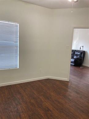 Austin apartment for rent - A room with wooden flooring and a window with blinds.
