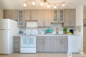 Honolulu apartment for rent - A kitchen with wooden cabinets and white appliances.
