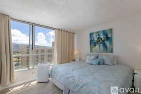 Honolulu apartment for rent - A bedroom with a large bed and a view of the city.