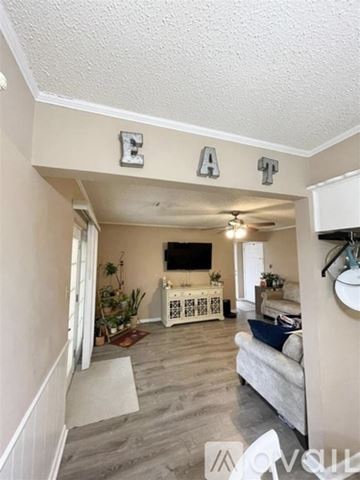 Lawton house for rent - A living room with a couch and a TV.