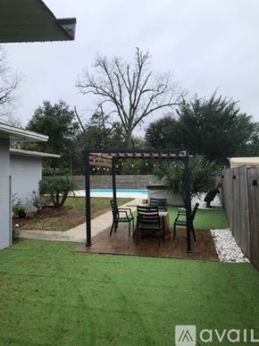 Jacksonville house for rent - A backyard with a pool and a pergola.