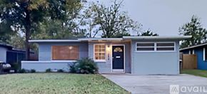 Jacksonville house for rent - A house with a blue exterior and a black door is available for sale.