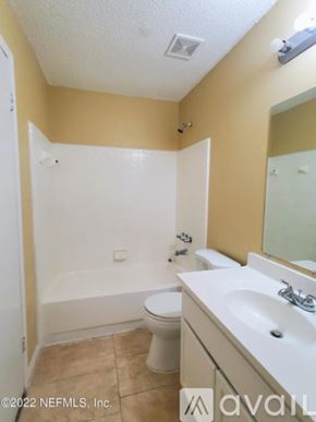 Jacksonville townhouse for rent - A bathroom with a toilet, sink, and bathtub.