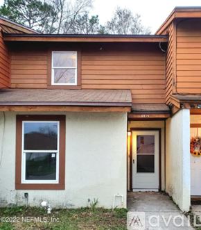 Jacksonville townhouse for rent - A house with a brown roof and a white door.