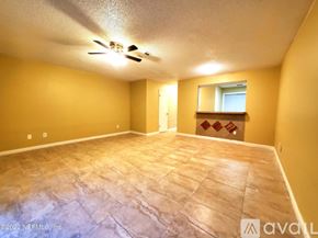 Jacksonville townhouse for rent - A room with a ceiling fan and a window with a view of a building outside.