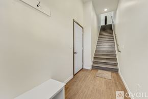 North Mankato townhouse for rent - A staircase with a white door at the bottom.