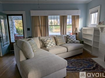 Asheville house for rent - A living room with a large sectional sofa and a rug.