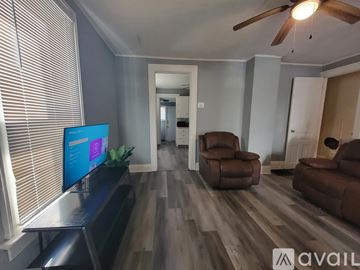Dayton house for rent - A living room with a television and two chairs.
