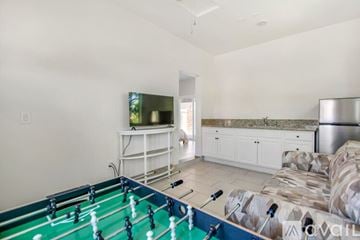 Indio house for rent - A foosball table is in the middle of a living room.