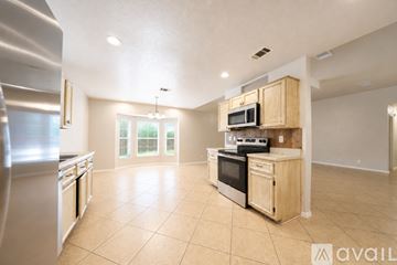 Killeen house for rent - A kitchen with wooden cabinets and appliances is available for rent.