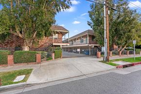 Burbank apartment for rent - A residential street with a house and a tree in front.