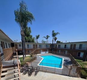 Pomona multi-family for rent - A pool surrounded by buildings.