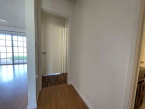 Kapolei apartment for rent - A room with white walls and a wooden floor.