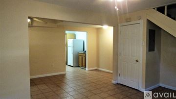 Biloxi apartment for rent - A kitchen area with a refrigerator and a cabinet.