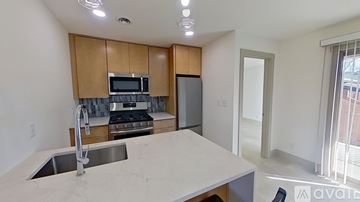 Huntington apartment for rent - A kitchen with a sink, stove, and microwave.