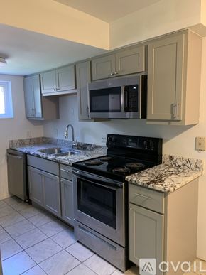 Cincinnati apartment for rent - A kitchen with a granite countertop and stainless steel appliances.