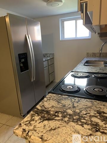 Cincinnati apartment for rent - A kitchen with a stainless steel refrigerator and a granite countertop.
