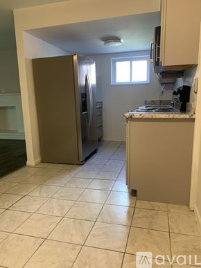 Cincinnati apartment for rent - A kitchen with a refrigerator, stove, and cabinets.