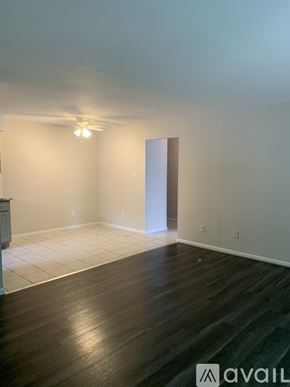 Cincinnati apartment for rent - A room with wooden floors and a ceiling fan.