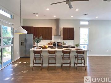 Phoenix apartment for rent - A modern kitchen with wooden cabinets and a central island.