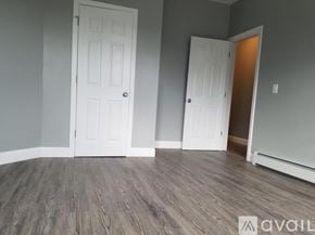 Boston apartment for rent - A room with two white doors and wooden flooring.