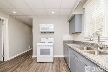 Chicago apartment for rent - A kitchen with a white oven and microwave.