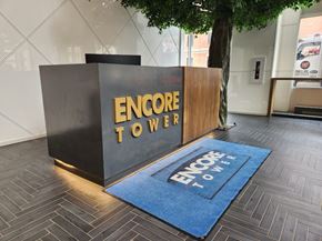 Edmonton apartment for rent - A sign that says Encore Tower is on a black and wood panel.