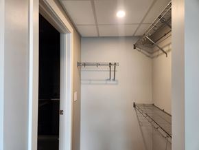 Edmonton apartment for rent - A white wall with a metal shelf and a door.