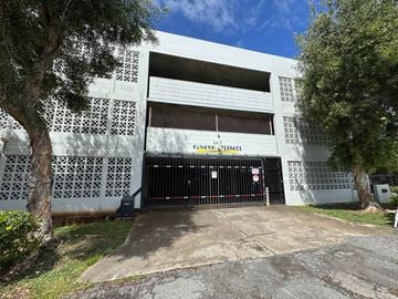 Honolulu apartment for rent - A white building with a black gate and the words "KINAWAY BASE" written on it.