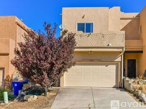 Albuquerque house for rent - A house with a brown exterior and a white garage door.