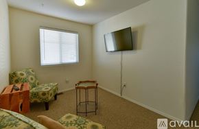 Albuquerque house for rent - A living room with a sofa, chair, and television.