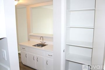 Norcross house for rent - A white kitchen with a sink and cabinets.