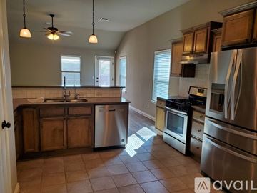 Edmond house for rent - A kitchen with wooden cabinets and stainless steel appliances.