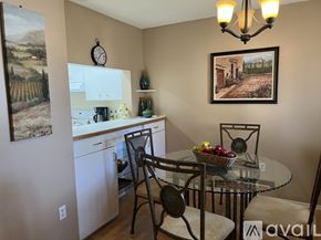 Sarasota condo for rent - A kitchen with a table and chairs and a painting on the wall.
