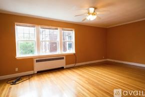 Brookline apartment for rent - A room with a fan, a window, and a heater.