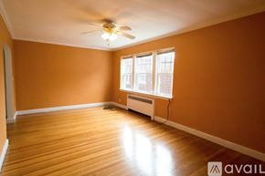 Brookline apartment for rent - A room with a ceiling fan and a window with blinds.