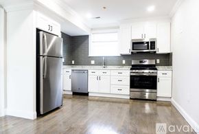 Boston apartment for rent - A kitchen with a refrigerator, oven, and microwave.