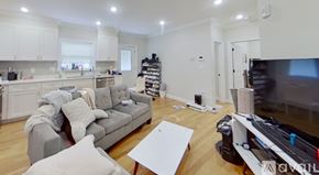 Boston apartment for rent - A living room with a grey couch and a white coffee table.