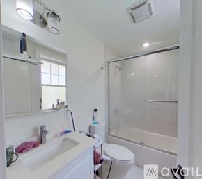 Boston apartment for rent - A white bathroom with a sink, toilet, and shower.
