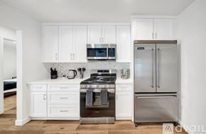 West Hills house for rent - A kitchen with white cabinets and stainless steel appliances.